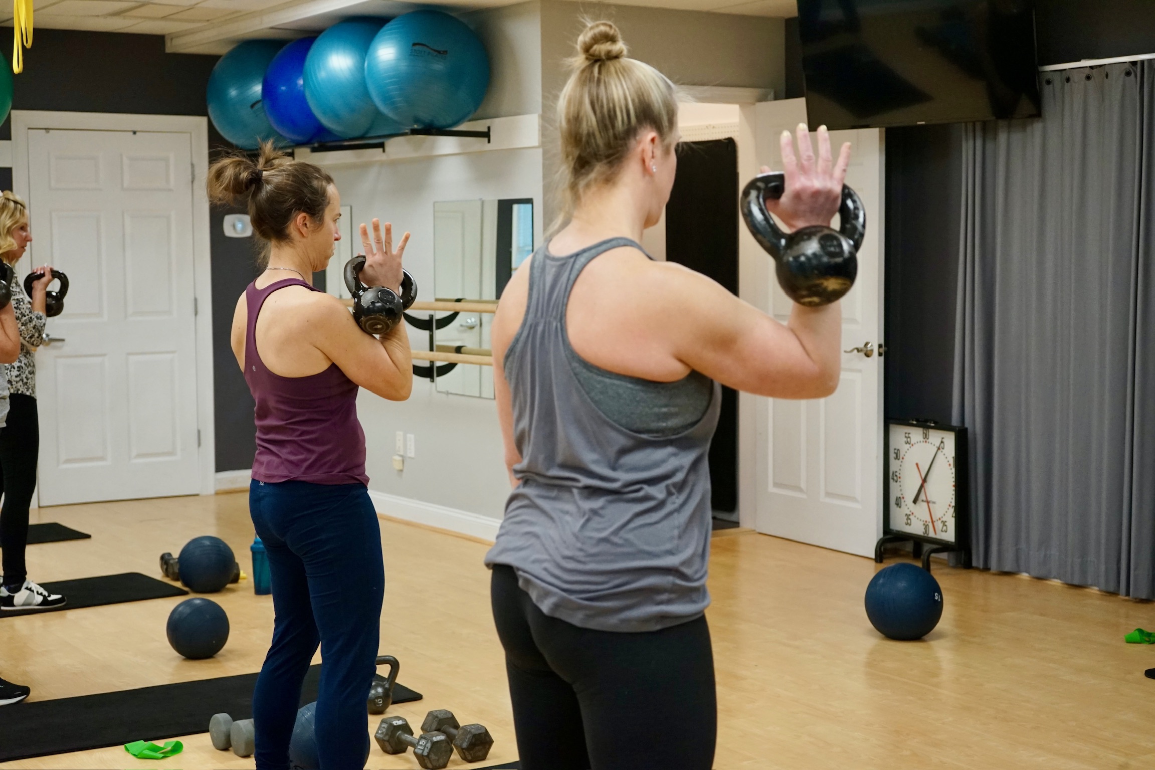 Strength training class with dumbbells at The Core Connection in Northborough, MA